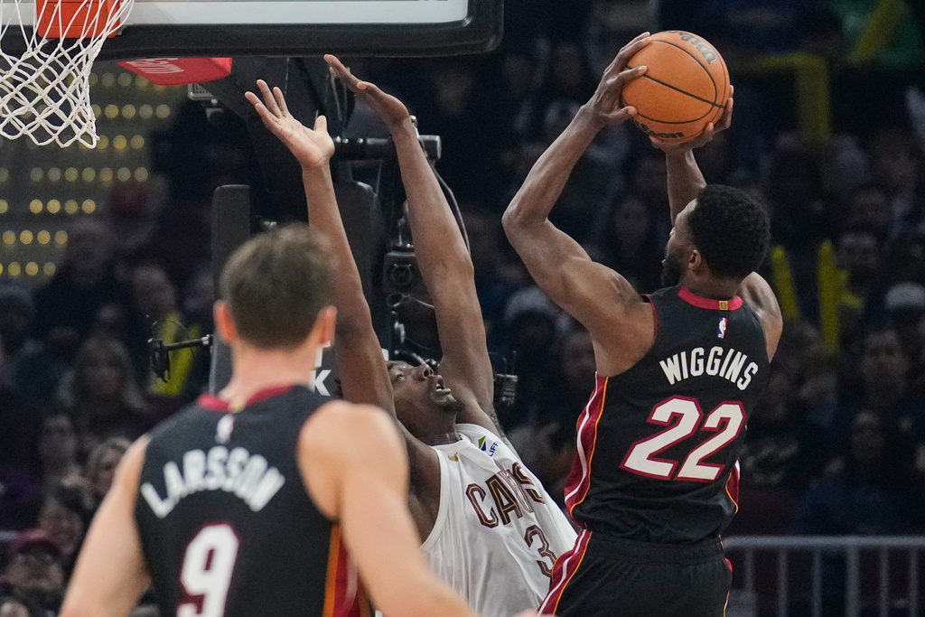 Miami Heat forward Andrew Wiggins (22) shoots over Cleveland Cavaliers center Thomas Bryant (3) in the first half of an NBA basketball game in Cleveland, Wednesday, March 25, 2026. (AP Photo/Sue Ogrocki)
