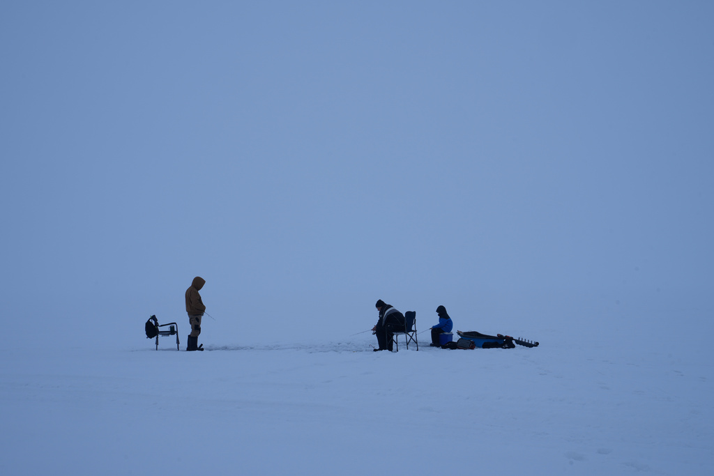 Fishermen cast their lines while ice fishing on Lake Simcoe in the Innisfil area north of Toronto, Wednesday, Jan. 7, 2026. (AP Photo/Kamran Jebreili)