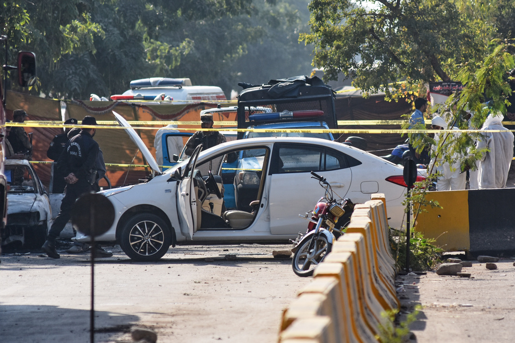 Pakistan's investigators examine the site following a suicide bombing outside the gates of a district court, in Islamabad, Pakistan, Tuesday, Nov. 11, 2025. (AP Photo/W.K. Yousufzai)