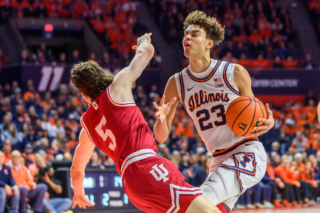 Illinois guard Keaton Wagler (23) drives to the basket against Conor Enright (5) during the first half of an NCAA college basketball game against Indiana Sunday, Feb. 15, 2026, in Champaign, Ill. (AP Photo/Craig Pessman)