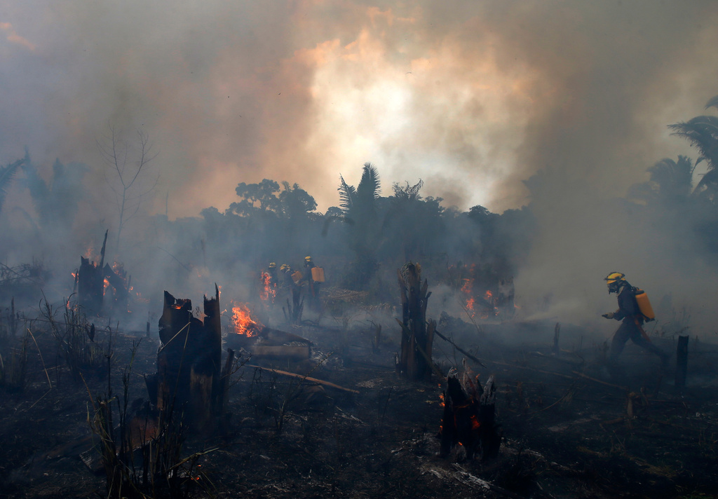 FILE - Fire brigade members work to put out a wildfire in Apui, Amazonas state, Brazil, Sept. 21, 2022. (AP Photo/Edmar Barros, File)