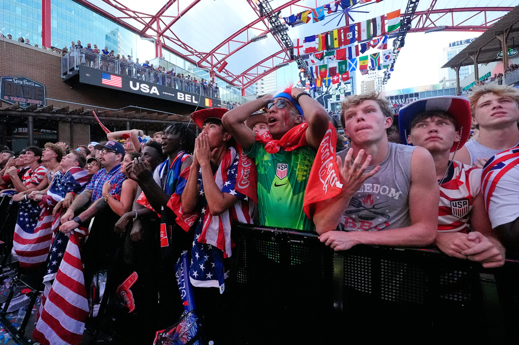 Fans react to a Belgium goal during a watch party for a World Cup round of 16 soccer match between the United States and Belgium at the KC Live! entertainment district Monday, July 6, 2026, in Kansas City, Mo. (AP Photo/Charlie Riedel)