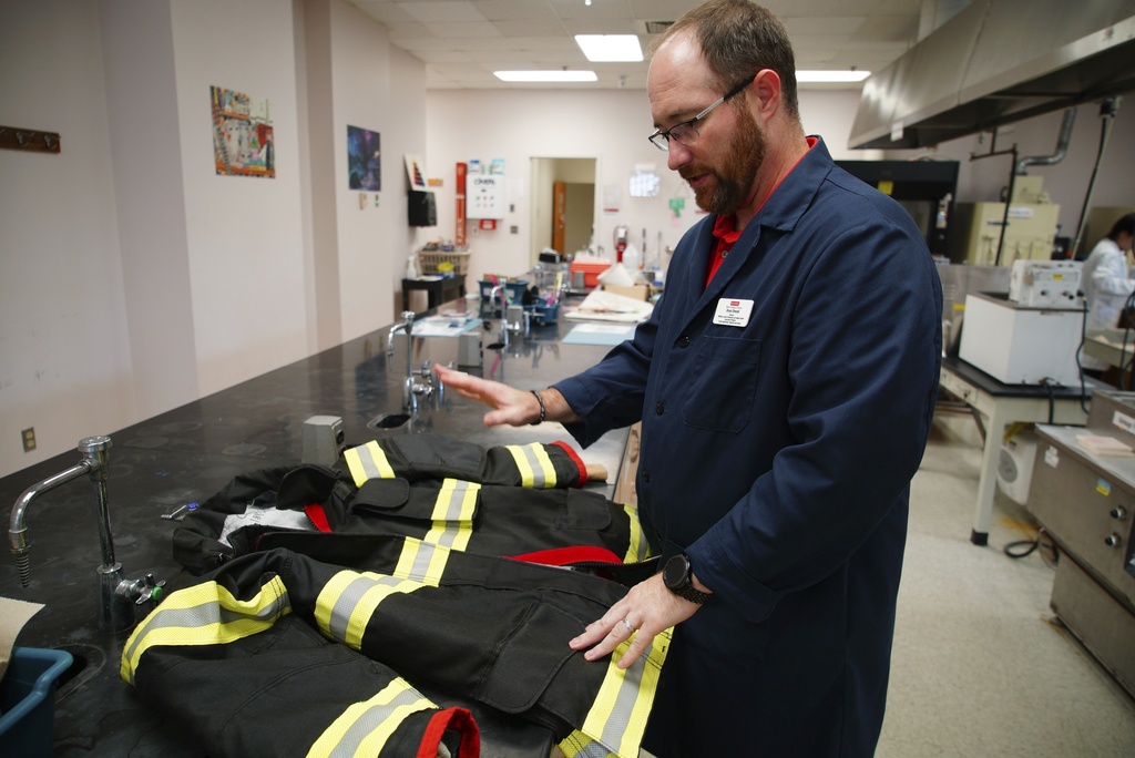 Bryan Ormond, a professor at the Textile Protection and Comfort Center at North Carolina State University, talks about the protective layers in a firefighter jacket on Aug. 8, 2025, in Raleigh, N.C. (AP Photo/Allen G. Breed)