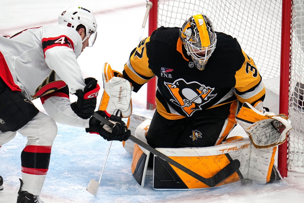 Pittsburgh Penguins goaltender Arturs Silovs (37) blocks a shot by Ottawa Senators' Tyler Kleven (43) during the first period of an NHL hockey game in Pittsburgh, Monday, Feb. 2, 2026. (AP Photo/Gene J. Puskar)