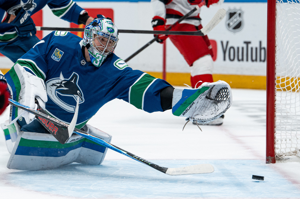 Carolina Hurricanes' Nikolaj Ehlers, not seen, scores on Vancouver Canucks goaltender Leevi Merilainen (31) during the first period of an NHL hockey game in Vancouver on Tuesday, Oct. 20, 2026. (Ethan Cairns/The Canadian Press via AP)