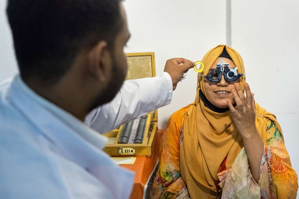 An eye care professional from VisionSpring examines a worker at a garment factory in Gazipur, on the outskirts of Dhaka, Bangladesh, June 30, 2026. (AP Photo/Rajib Dhar)