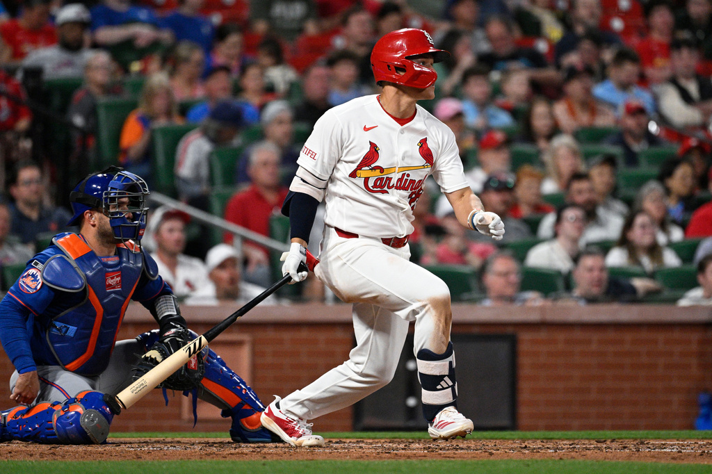 St. Louis Cardinals' JJ Wetherholt, right, watches his single next to New York Mets catcher Luis Torrens in the third inning of a baseball game, Tuesday, March 31, 2026, in St. Louis. (AP Photo/Joe Puetz)