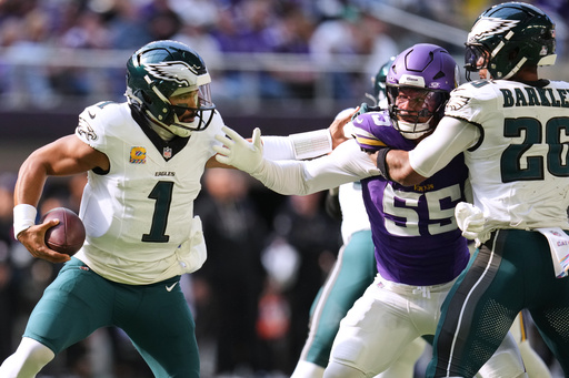 Philadelphia Eagles quarterback Jalen Hurts (1) tries to avoid a tackle from Minnesota Vikings linebacker Eric Wilson (55) during the first half of an NFL football game Sunday, Oct. 19, 2025, in Minneapolis. (AP Photo/Abbie Parr) Philadelphia Eagles quarterback Jalen Hurts (1) tries to avoid a tackle from Minnesota Vikings linebacker Eric Wilson (55) during the first half of an NFL football game Sunday, Oct. 19, 2025, in Minneapolis. (AP Photo/Abbie Parr)