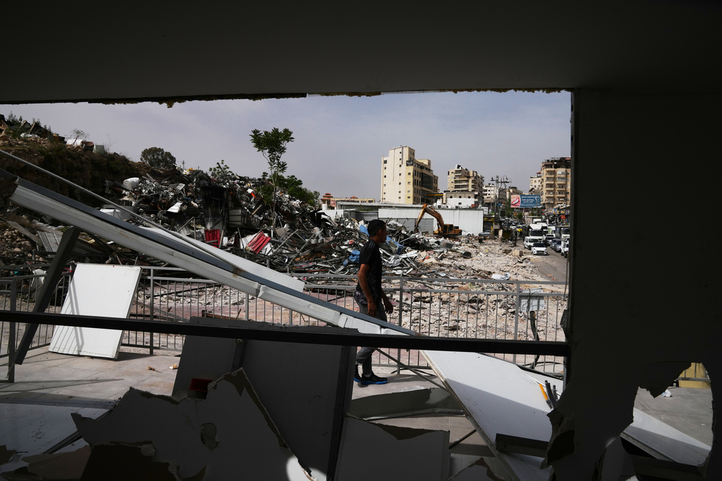 A man inspects the site of an Israeli army demolition campaign that targeted several Palestinian commercial structures overnight, days after the issue of demolition and evacuation orders to owners, in the West Bank town of Al-Eizariya Tuesday, May 12, 2026. (AP Photo/Mahmoud Illean)