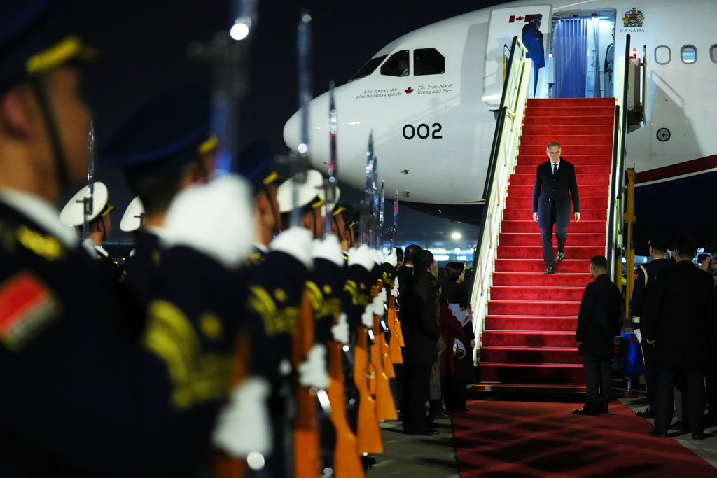 Canada's Prime Minister Mark Carney deplanes during a welcome ceremony in Beijing, China, Wednesday, Jan. 14, 2026. (The Canadian Press/Sean Kilpatrick, via AP)