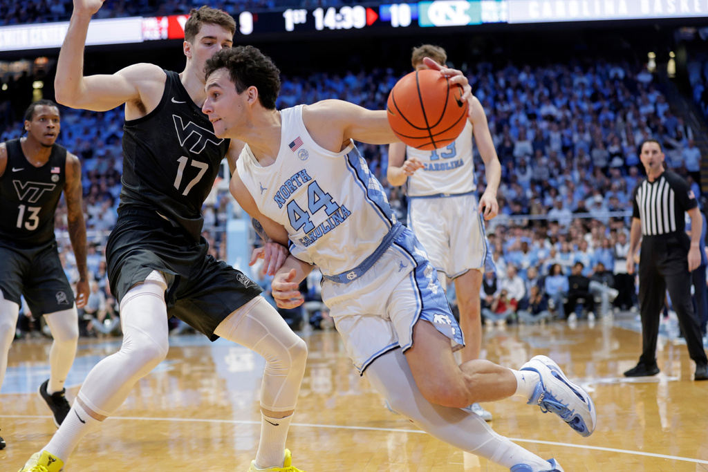 North Carolina guard Luka Bogavac (44) drives against Virginia Tech guard Neoklis Avdalas (17) during the first half of an NCAA college basketball game Saturday, Feb. 28, 2026, in Chapel Hill, N.C. (AP Photo/Chris Seward)