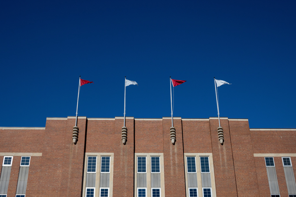 FILE - Flags fly at the Reynolds Coliseum at North Carolina State University, Feb. 19, 2022, in Raleigh, N.C. (AP Photo/Kara Durrette, File)
