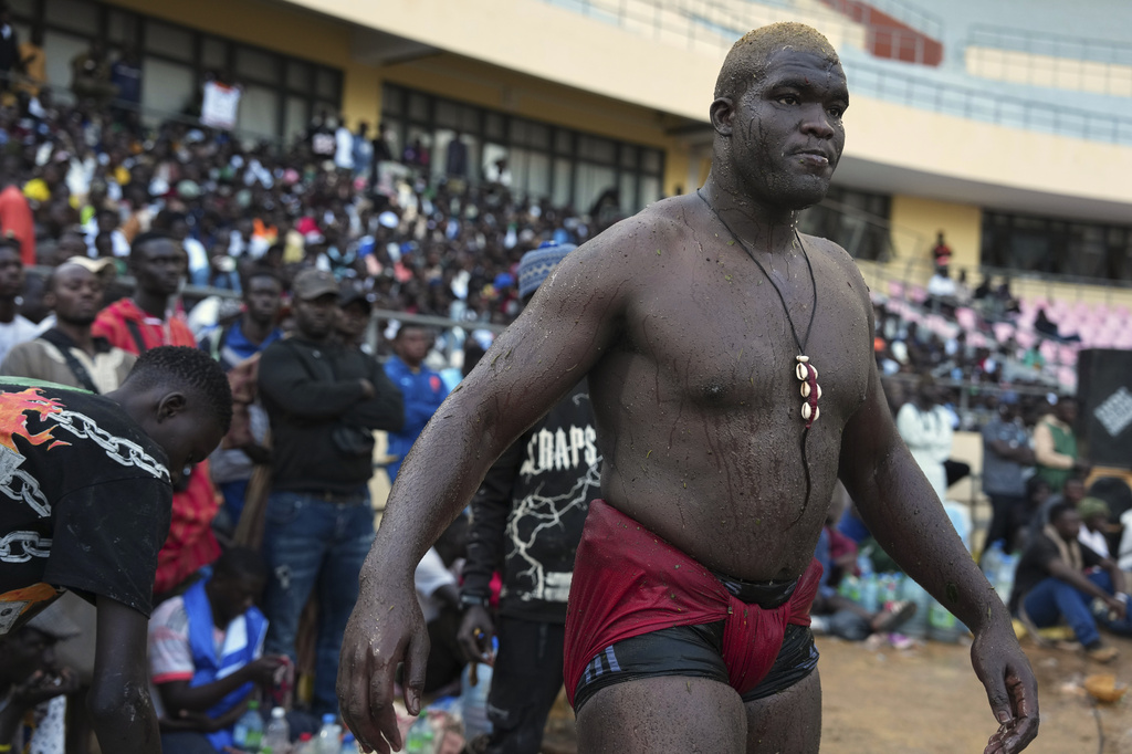A wrestler waits to compete at the national wrestling arena in Dakar, Senegal, Sunday, March 29, 2026. (AP Photo/Misper Apawu)