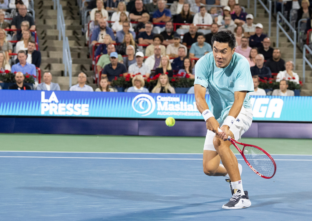 Brandon Nakashima of the United States hits a return to Ben Shelton during final tennis action at the National Bank Open in Montreal on Thursday, Aug. 13, 2026. (Christinne Muschi/The Canadian Press via AP)