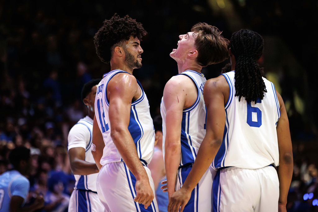 Duke's Nikolas Khamenia, center, celebrates after a play with Cameron Boozer, left, and Maliq Brown (6) during the first half of an NCAA college basketball game against Indiana State in Durham, N.C., Friday, Nov. 14, 2025. (AP Photo/Ben McKeown)