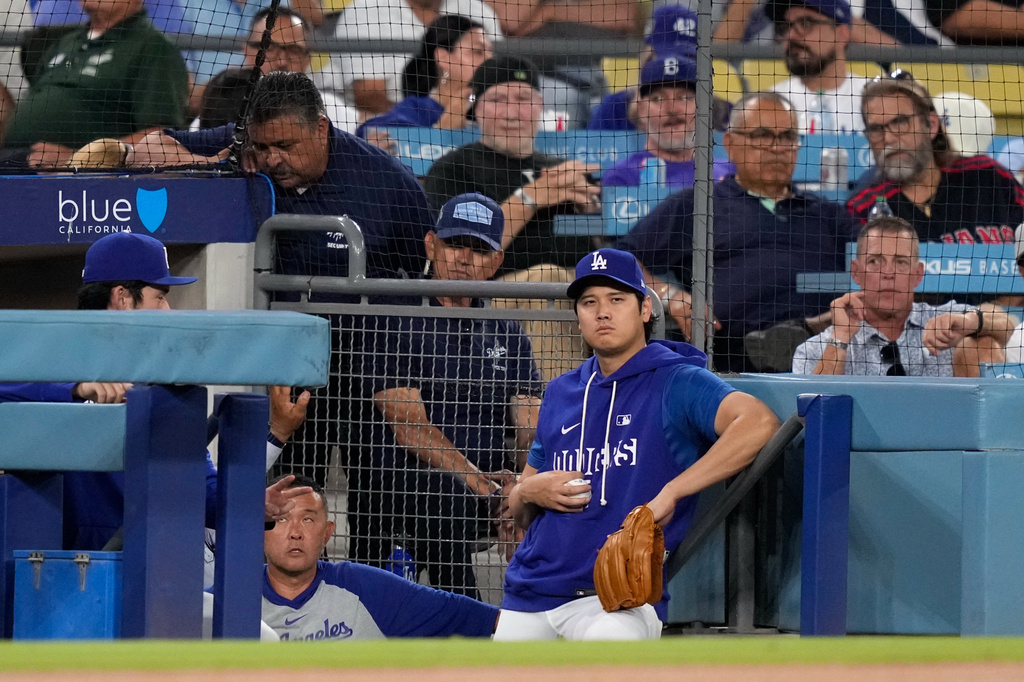 Los Angeles Dodgers' Shohei Ohtani watches from the dugout during the first inning of a baseball game against the Cincinnati Reds, Tuesday, Sept. 8, 2026, in Los Angeles. (AP Photo/Mark J. Terrill)