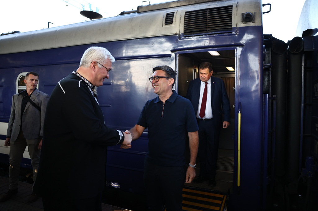 Ukraine's Foreign Affairs Minister Andrii Sybiha, left, greets Britain's prime minister Andy Burnham upon his arrival by train, in Kyiv, Monday, Aug. 24, 2026. (Henry Nicholls/Pool Photo via AP)
