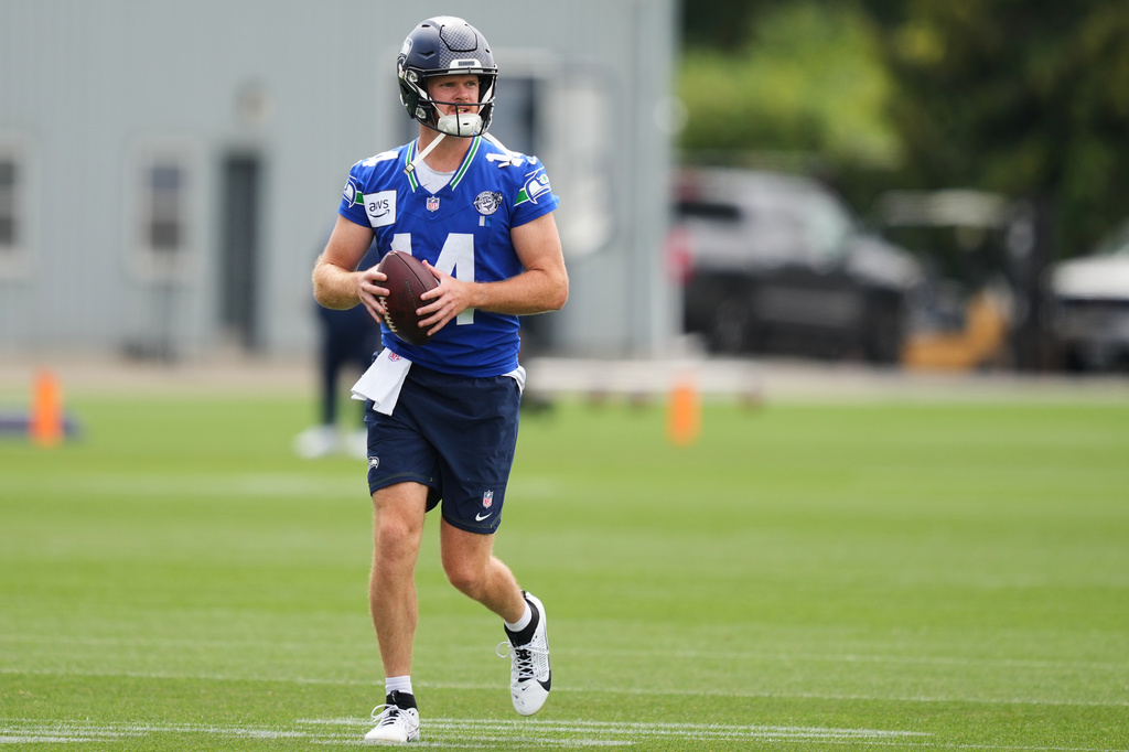 Seattle Seahawks quarterback Sam Darnold carries a ball during the NFL football team's training camp, Sunday, July 26, 2026, in Renton, Wash. (AP Photo/Lindsey Wasson)