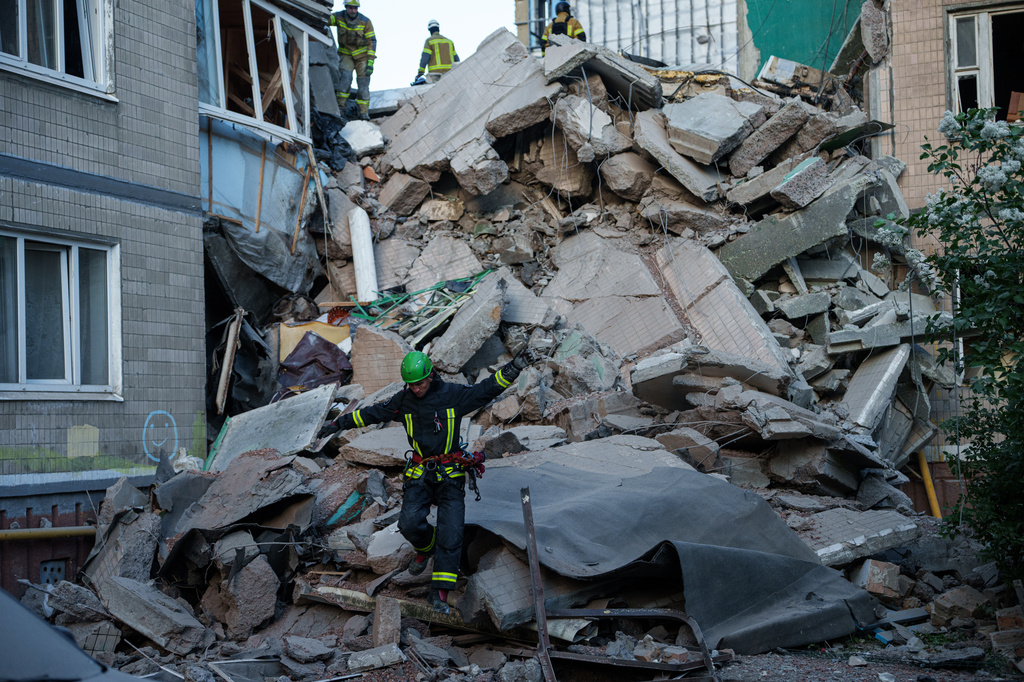 A rescue worker walks on the rubble of a house heavily damaged after a Russian strike on residential neighbourhood in Kyiv, Ukraine, on Thursday, May 14, 2026. (AP Photo/Evgeniy Maloletka)