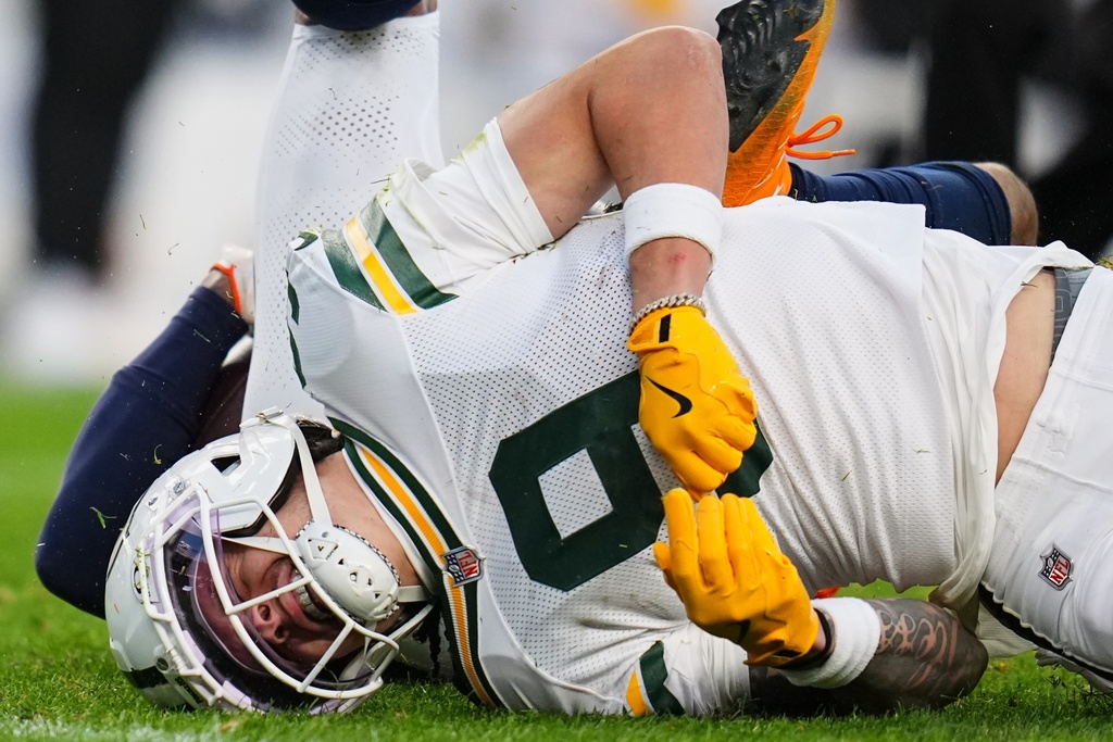Green Bay Packers' Christian Watson reacts after an injury during the second half of an NFL football game against the Denver Broncos Sunday, Dec. 14, 2025, in Denver. (AP Photo/Jack Dempsey)