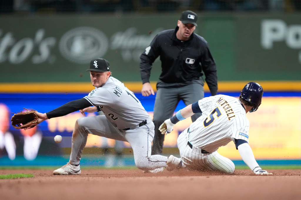 Milwaukee Brewers' Garrett Mitchell (5) steals second base against Chicago White Sox shortstop Colson Montgomery (12) during the seventh inning of a baseball game, Saturday, March 28, 2026, in Milwaukee. (AP Photo/Kayla Wolf)