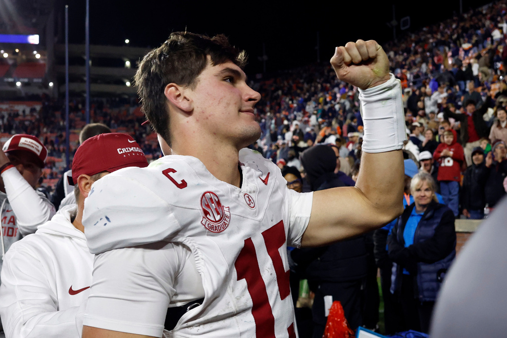 Alabama quarterback Ty Simpson celebrates after a win over Auburn in an NCAA college football game, Saturday, Nov. 29, 2025, in Auburn, Ala. (AP Photo/Butch Dill)