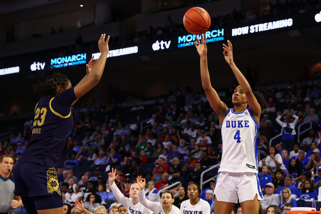 Duke guard Riley Nelson (4) shoots over Notre Dame guard Iyana Moore (23) during the second half of an NCAA college basketball game in the semifinals of the Atlantic Coast Conference tournament, Saturday, March 7, 2026, in Duluth, Ga. (AP Photo/Colin Hubbard)