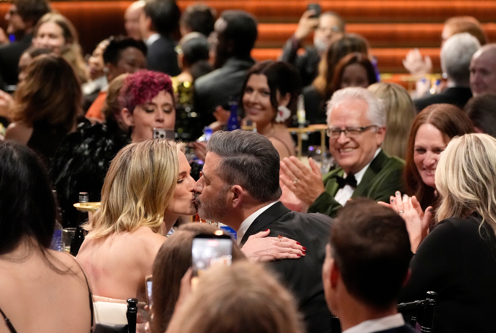 Jimmy Kimmel, right, kisses his wife, Molly McNearney, in the audience during the 31st Annual Critics Choice Awards on Sunday, Jan. 4, 2026, at The Barker Hanger in Santa Monica, Calif. (AP Photo/Chris Pizzello)