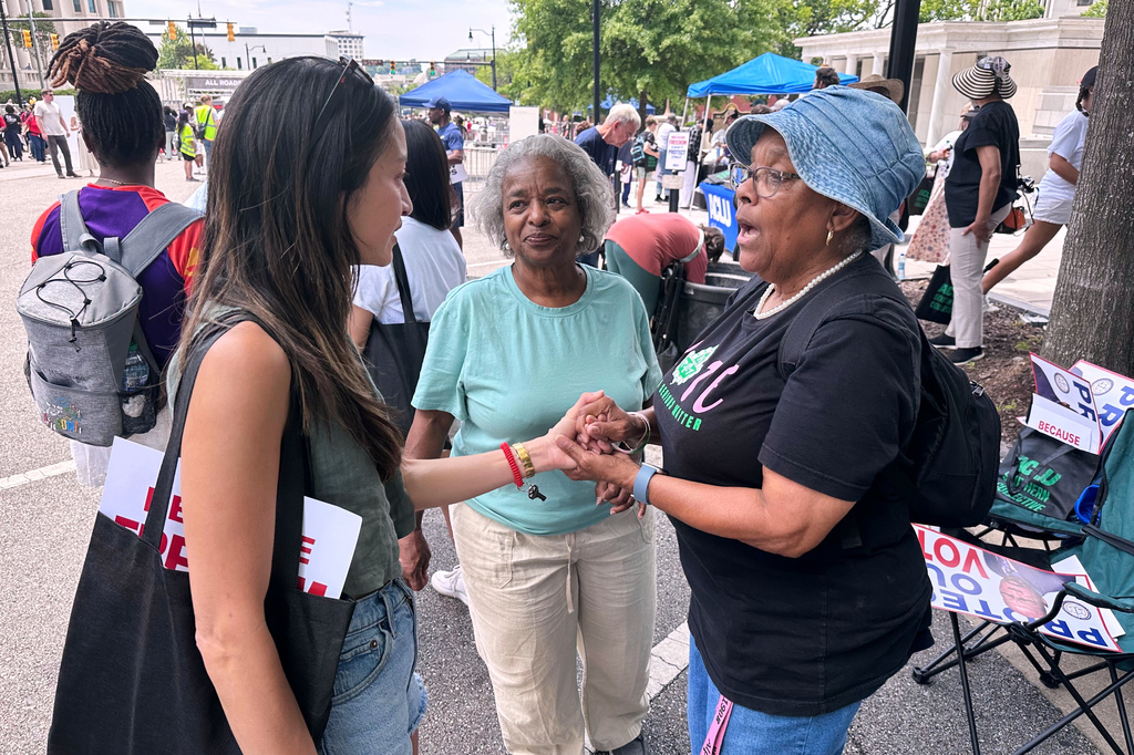 Bee Nguyen, left, talks to Carole Burton, center, and Tondalaire Ashford at a voting rights rally Saturday, May 16, 2026, in Montgomery, Ala. (AP Photo/Bill Barrow)