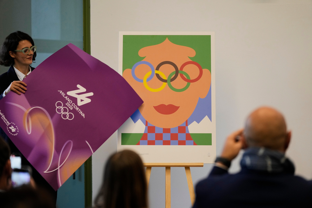 Artist Olimpia Zagnoli unveils the Milano-Cortina 2026 Winter Olympics iconic poster during a press conference at Milan's Triennale permanent exhibition in Milan, Italy, Wednesday, Oct. 22, 2025. (AP Photo/Luca Bruno)