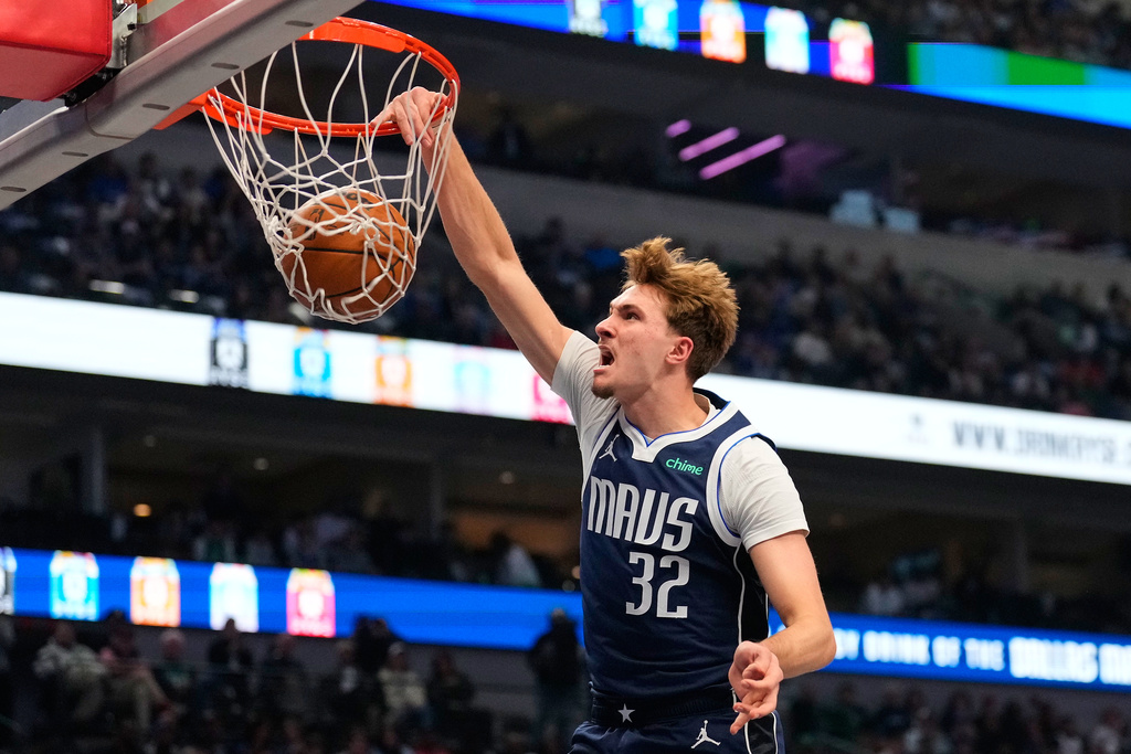 Dallas Mavericks forward Cooper Flagg (32) dunks in the first half of an NBA basketball game against the Detroit Pistons in Dallas, Thursday, Dec. 18, 2025. (AP Photo/Tony Gutierrez)