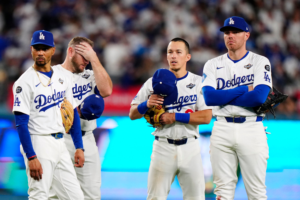 Los Angeles Dodgers shortstop Mookie Betts (50) third baseman Max Muncy (13) second baseman Tommy Edman (25) and first baseman Freddie Freeman (5) look on during a pitching change during seventh inning Game 5 World Series playoff MLB baseball action against the Toronto Blue Jays in Los Angeles on Wednesday, Oct. 29, 2025. (Frank Gunn/The Canadian Press via AP)