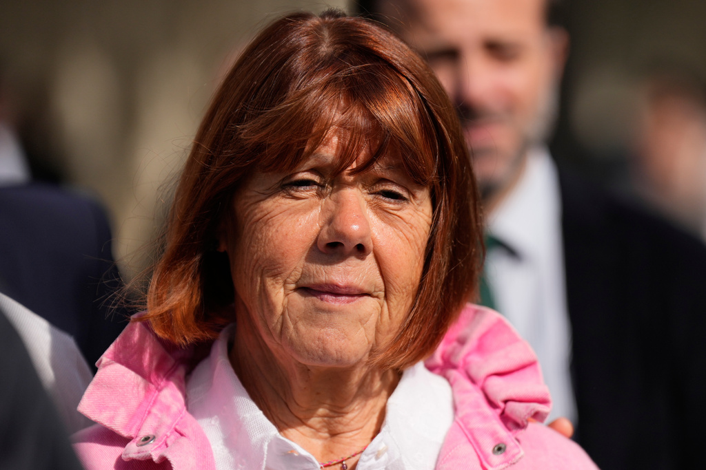 Gisele Pelicot leaves the courthouse for a break during the appeals trial in the case of a man challenging his conviction, less than a year after the landmark verdict in a drugging and rape trial that shook France Thursday, Oct. 9, 2025 in Nimes, southern France. (AP Photo/Lewis Joly)