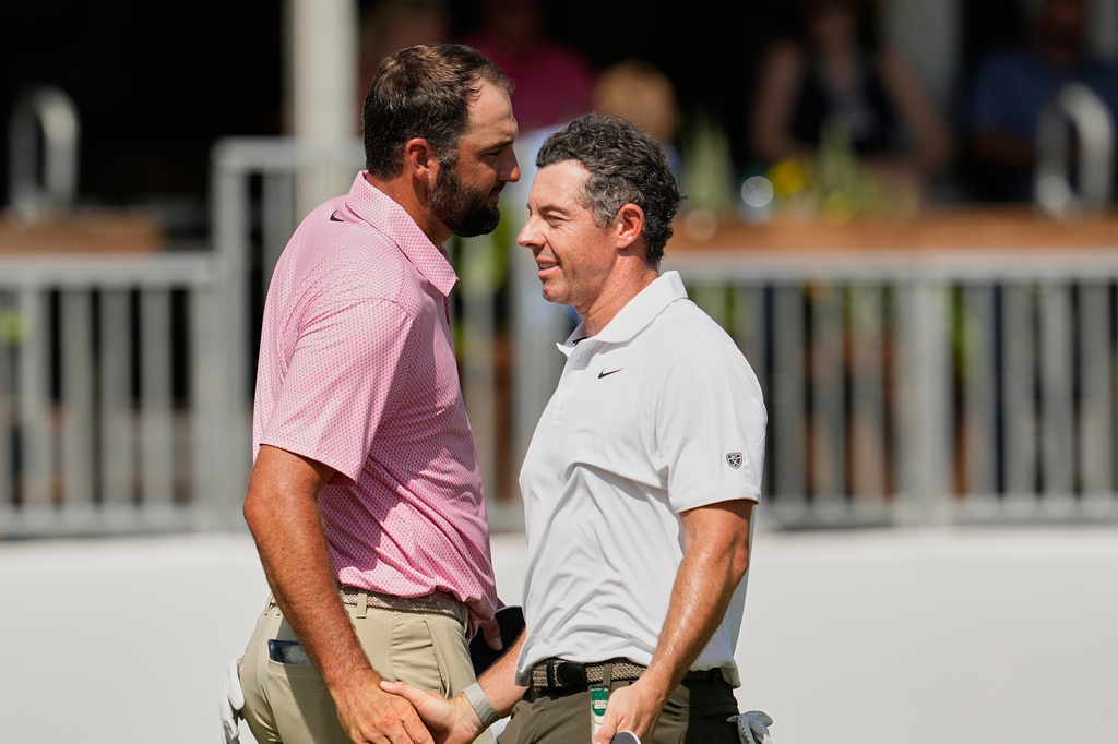 Scottie Scheffler, left, and Rory McIlroy, of Northern Ireland, shake hands after finishing the second round of the St. Jude Championship golf tournament Friday, Aug. 14, 2026, in Memphis, Tenn. (AP Photo/George Walker IV)
