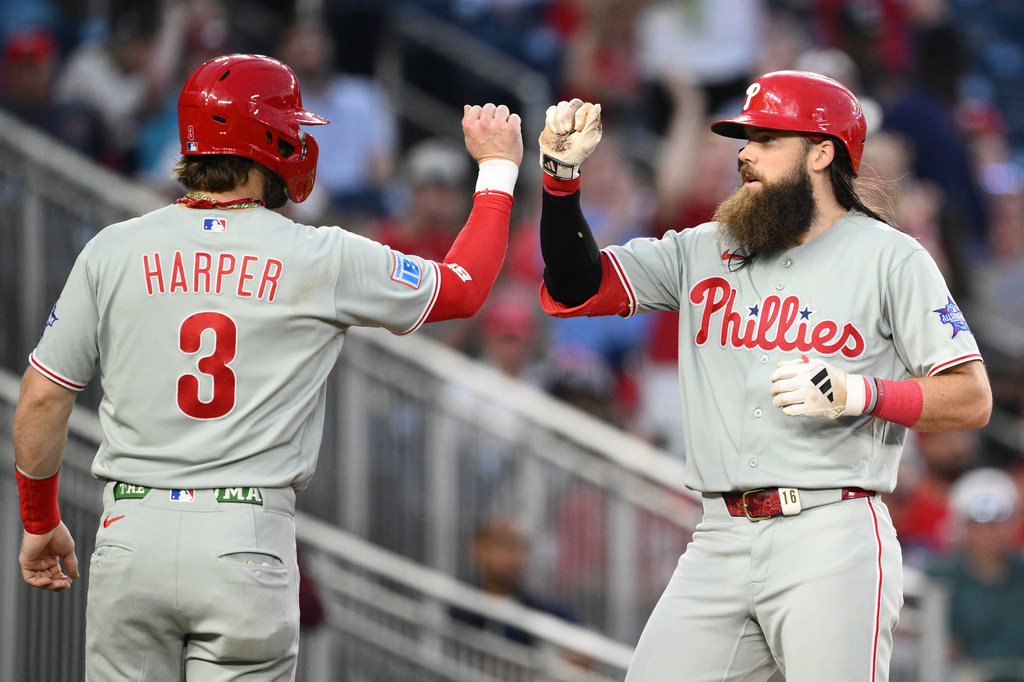 Philadelphia Phillies' Brandon Marsh, right, celebrates his two-run home run with Bryce Harper (3) during the sixth inning of a baseball game against the Washington Nationals, Thursday, June 25, 2026, in Washington. (AP Photo/Nick Wass)