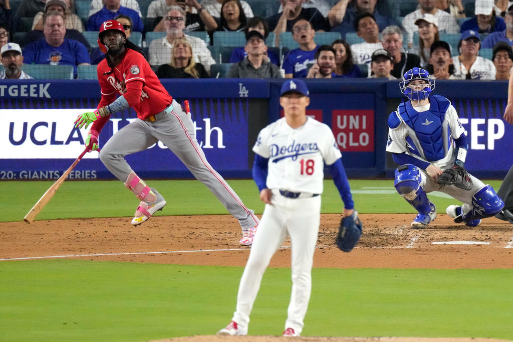 Cincinnati Reds' Elly De La Cruz, left, heads to first for a solo home run as Los Angeles Dodgers pitcher Yoshinobu Yamamoto, center, watches along with catcher Will Smith during the fourth inning of a baseball game Wednesday, Sept. 9, 2026, in Los Angeles. (AP Photo/Mark J. Terrill)