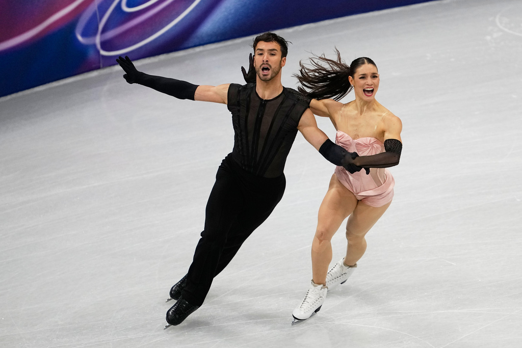 Laurence Fournier Beaudry and Guillaume Cizeron of France compete during the figure skating ice dance team event at the 2026 Winter Olympics, in Milan, Italy, Friday, Feb. 6, 2026. (AP Photo/Ashley Landis)