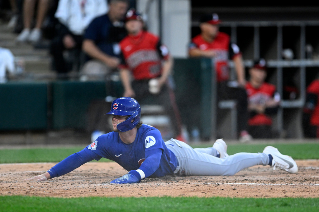 Chicago Cubs' Nico Hoerner slides into home plate safely on a Michael Busch double during the fifth inning of a baseball game against the Chicago White Sox in Chicago, Friday, May 15, 2026. (AP Photo/Paul Beaty)