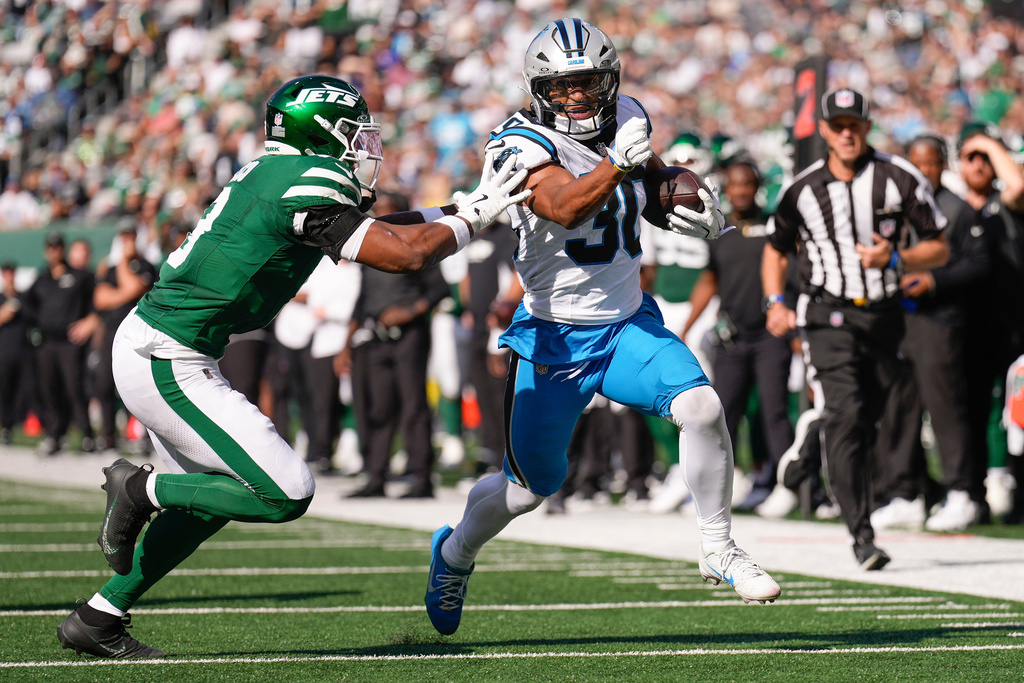 New York Jets safety Andre Cisco (8) pushes Carolina Panthers running back Chuba Hubbard (30) out of bounds during the second quarter of an NFL football game, Sunday, Oct. 19, 2025, in East Rutherford, N.J. (AP Photo/Seth Wenig)
