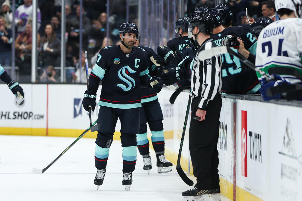 Seattle Kraken right wing Jordan Eberle (7) celebrates a goal with the bench in the second period against the Vancouver Canucks during an NHL hockey game Saturday, Feb. 28, 2026, in Seattle. (AP Photo/Kevin Ng)