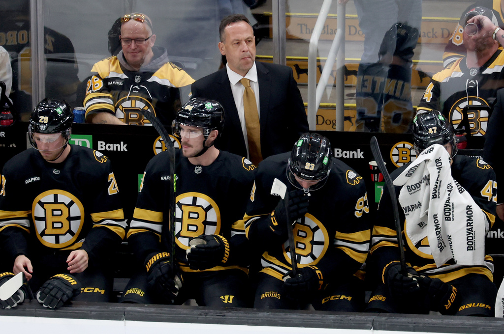 Boston Bruins head coach Marco Sturm, center top, watches from the bench during the first period of an NHL hockey game against the Chicago Blackhawks, Thursday, Oct. 9, 2025, in Boston. (AP Photo/Mark Stockwell)