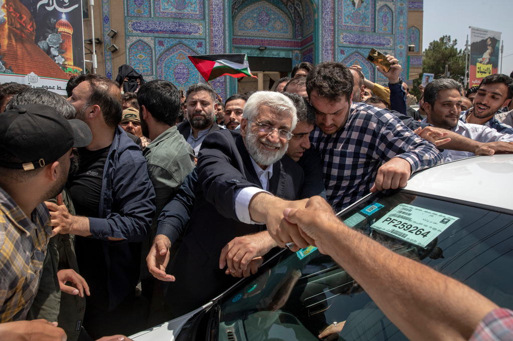 FILE - Candidate for Iran's presidential election Saeed Jalili, a hard-line former nuclear negotiator, shakes hands with a supporter after casting his vote for the presidential runoff election in Qarchak, near Tehran, Iran, July 5, 2024. (AP Photo, File)