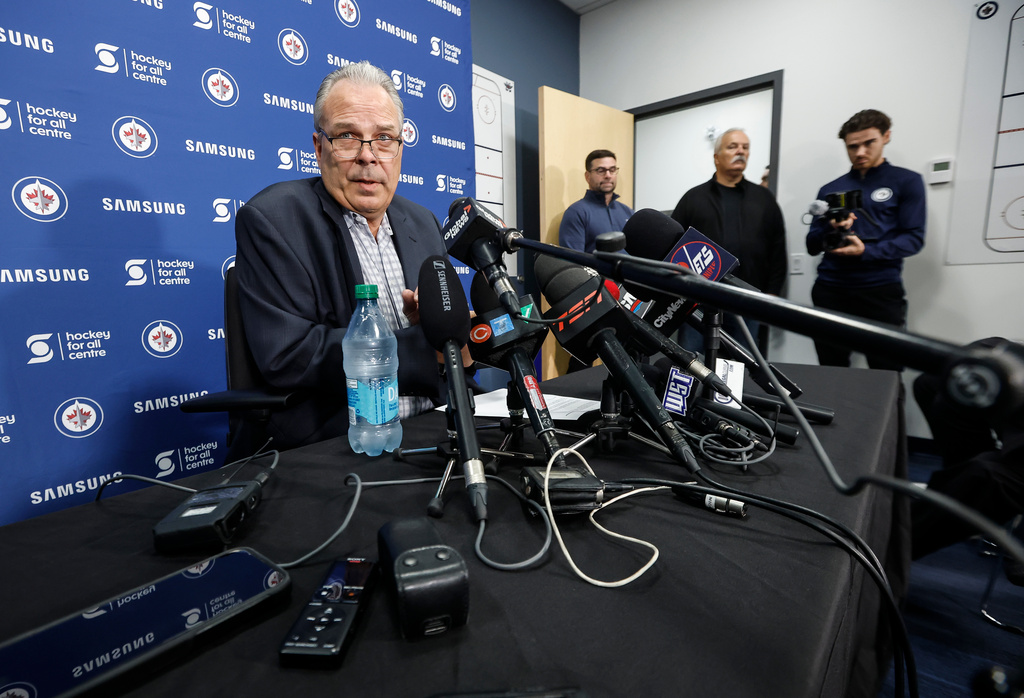 Winnipeg Jets general manager Kevin Cheveldayoff talks to media regarding the suspension of Connor Hellebuyck during the NHL hockey team's training camp in Winnipeg, Manitoba, Thursday, Sept. 17, 2026. (John Woods/The Canadian Press via AP)