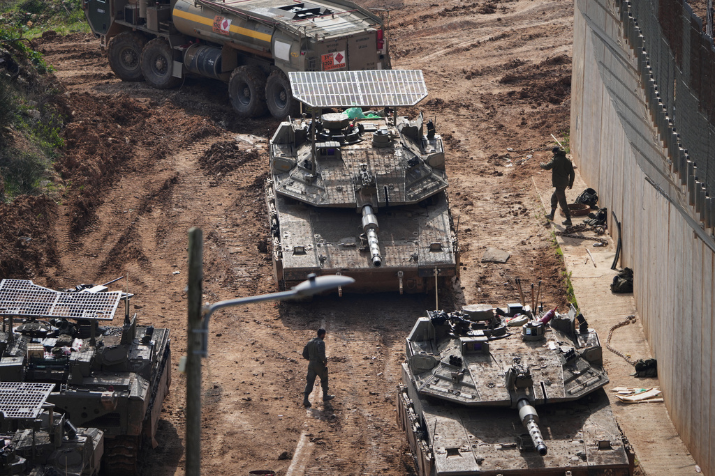 Israeli tanks maneuver near the Israel-Lebanon border, in northern Israel, Wednesday, March 4, 2026. (AP Photo/Ariel Schalit)