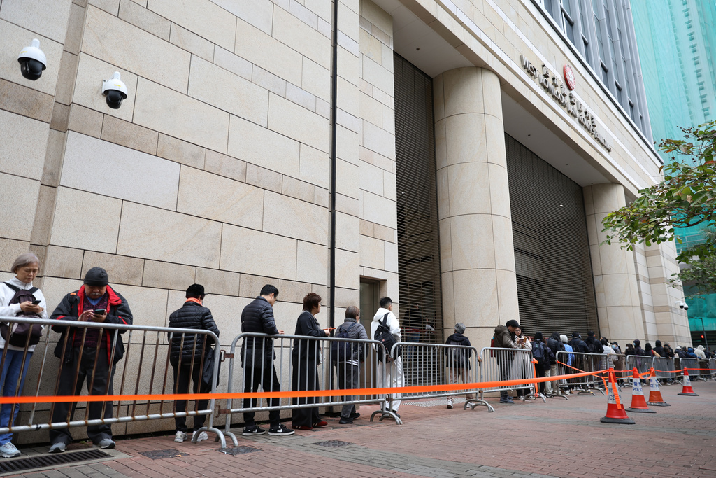 People line up behind the barricades to attend the hearing about the upcoming sentence for pro-democracy media mogul Jimmy Lai, outside the West Kowloon Magistrates' Courts, in Hong Kong, Monday, Jan. 12, 2026. (AP Photo/May James)