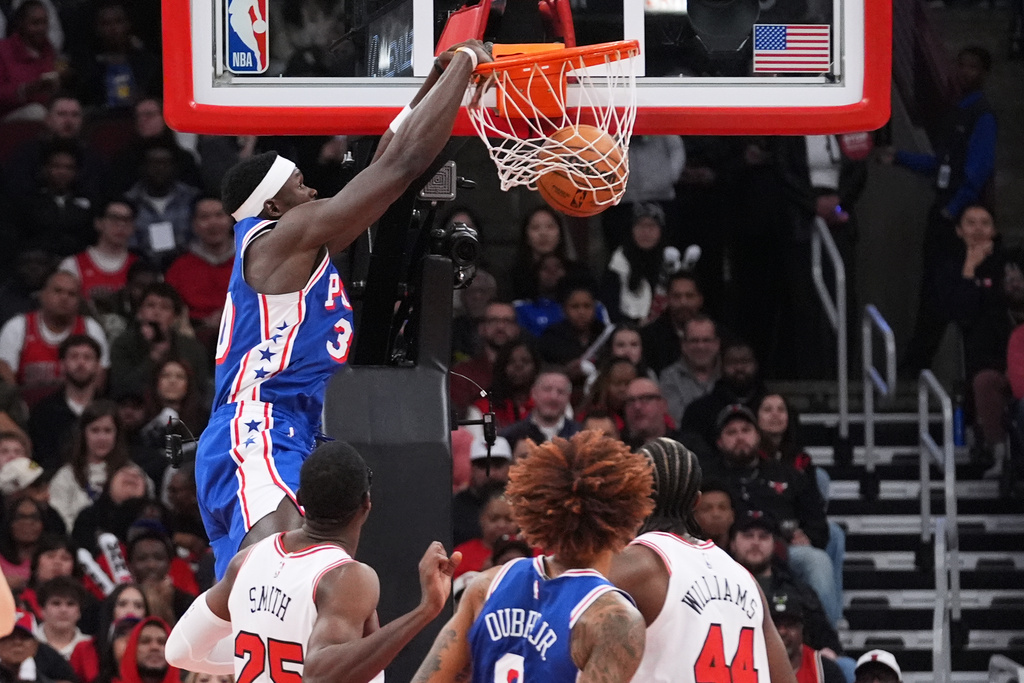 Philadelphia 76ers forward Adem Bona, top, dunks against the Chicago Bulls during the first half of an NBA basketball game in Chicago, Tuesday, Nov. 4, 2025. (AP Photo/Nam Y. Huh)
