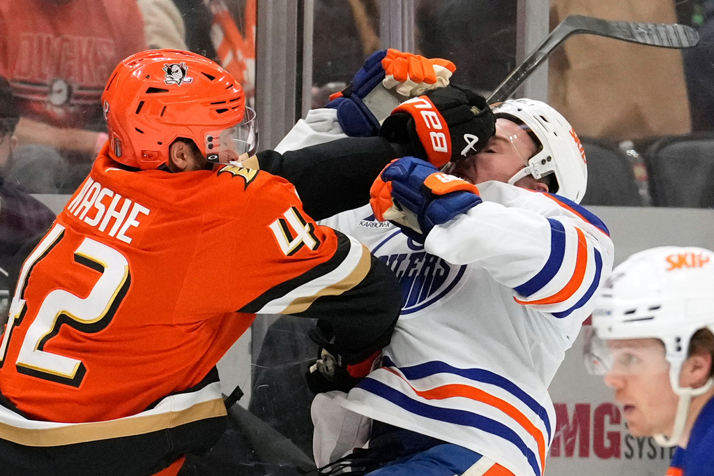 Anaheim Ducks center Tim Washe, left, puts a hit on Edmonton Oilers defenseman Ty Emberson during the second period of Game 6 in the first round of the NHL hockey Stanley Cup playoffs series Thursday, April 30, 2026, in Anaheim, Calif. (AP Photo/Mark J. Terrill)