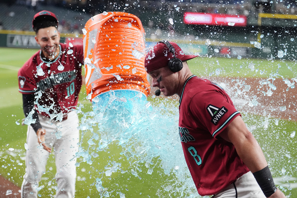 Arizona Diamondbacks' James McCann (8) gets doused in Gatorade by Diamondbacks' Jordan Lawlar (10) in celebration of McCann's eighth inning home run against the Philadelphia Phillies after a baseball game, Wednesday, Sept. 2, 2026, in Phoenix. (AP Photo/Ross D. Franklin)
