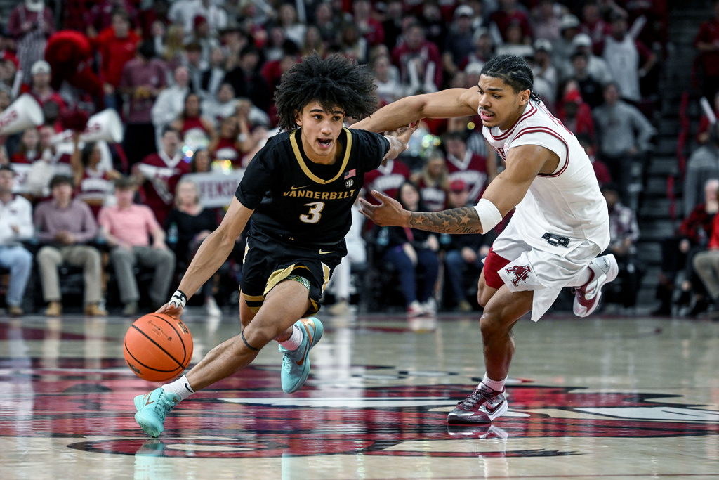 Vanderbilt guard Tyler Tanner (3) tries to drive past Arkansas guard Darius Acuff Jr. (5) during the second half of an NCAA college basketball game Tuesday, Jan. 20, 2026, in Fayetteville, Ark. (AP Photo/Michael Woods)