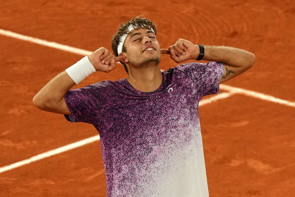 Italy's Flavio Cobolli reacts after winning the quarterfinal tennis match against Canada's Felix Auger-Aliassime at the French Open in Paris, Wednesday, June 3, 2026. (AP Photo/Aurelien Morissard)